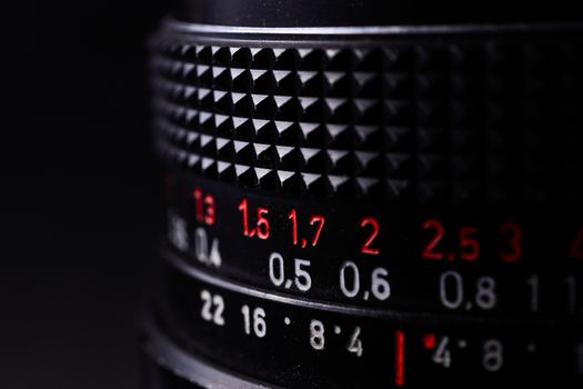 Vintage lens scale signs closeup. Stock photo with blurred gray background.