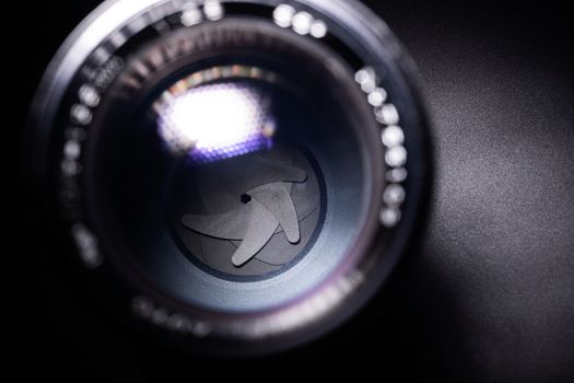 Vintage lens aperture closeup. Stock photo with blurred foreground.