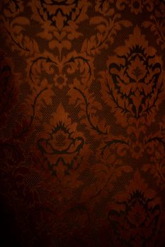 Expensive dark orange home curtains with a very beautiful frilly pattern. Texture shot. Good background or wallpapers.