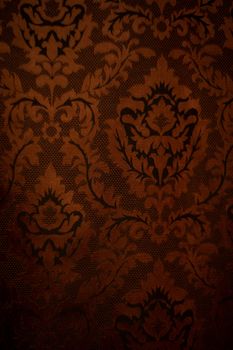 Expensive dark orange home curtains with a very beautiful frilly pattern. Texture shot. Good background or wallpapers.