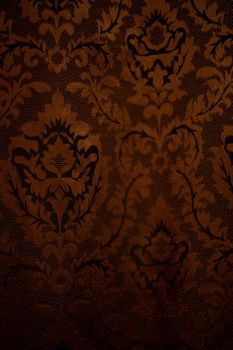 Expensive dark orange home curtains with a very beautiful frilly pattern. Texture shot. Good background or wallpapers.