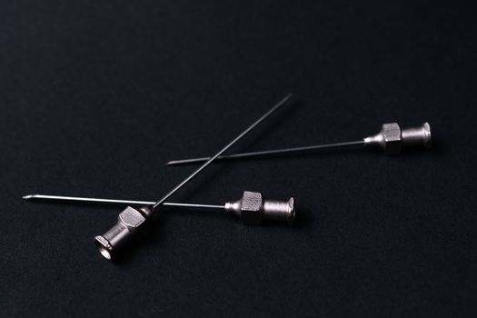Old rare metallic medical needles isolated on gray background. Needles new and clean.