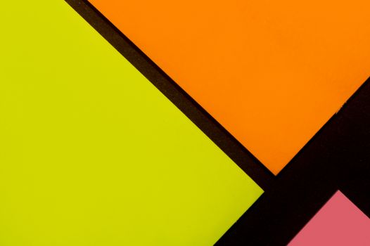 Yellow, orange and rose hue colorful office stickers on black paper. Office noteparer as reminder. Isolated on black paper.