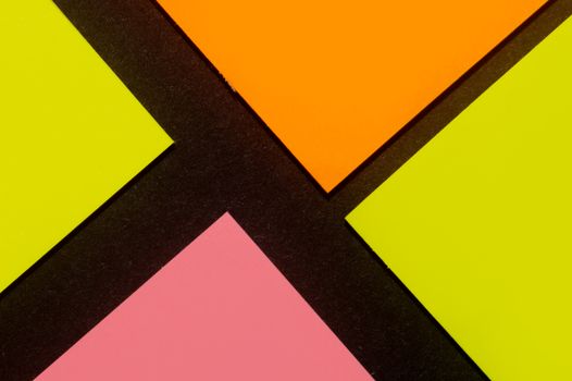 Yellow, orange and rose hue colorful office stickers on black paper. Office noteparer as reminder. Isolated on black paper.