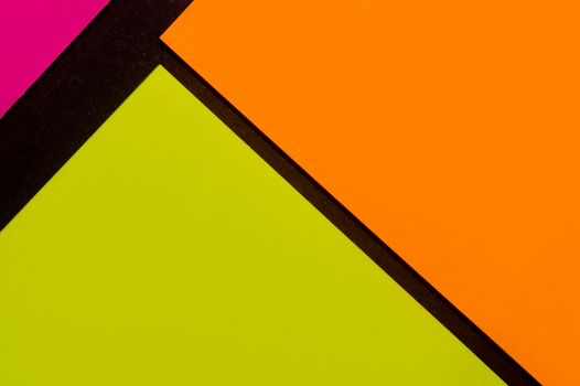 Purple, yellow and orange hue colorful office stickers on black paper. Office noteparer as reminder. Isolated on black paper.