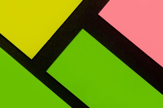 Green, yellow and rose hue colorful office stickers on black paper. Office noteparer as reminder. Isolated on black paper.