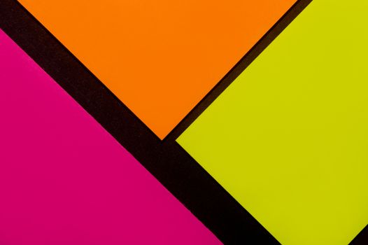 Purple, yellow and orange hue colorful office stickers on black paper. Office noteparer as reminder. Isolated on black paper.