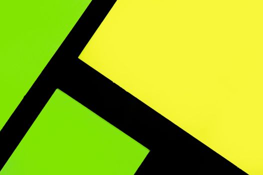 Green and yellow hue colorful office stickers on black paper. Office noteparer as reminder. Isolated on black paper.