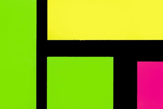 Green, yellow and purple hue colorful office stickers on black paper. Office noteparer as reminder. Isolated on black paper.