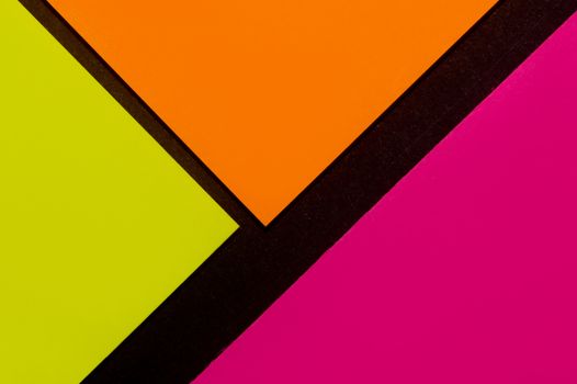 Purple, yellow and orange hue colorful office stickers on black paper. Office noteparer as reminder. Isolated on black paper.