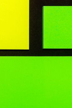 Green and yellow hue colorful office stickers on black paper. Office noteparer as reminder. Isolated on black paper.