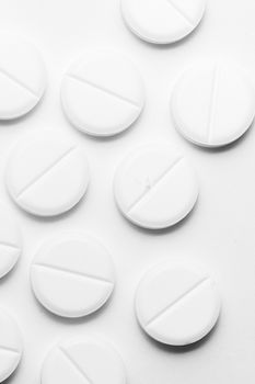 White pills on white background. Close-up view. Medical background. Healthcare image.