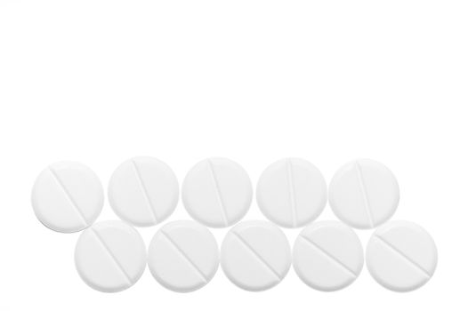 White pills isolated on white background. Close-up view. Medical background. Healthcare image.