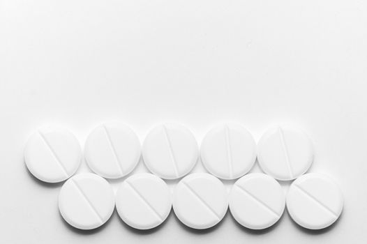 White pills on white background. Close-up view. Medical background. Healthcare image.