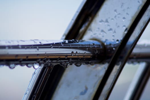 Chrome steel pipes with water drops in river port after rain.