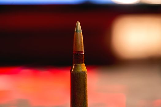 Rifle AK-47 ammo bullet close-up on blurred background. Armor piercing cartridge.