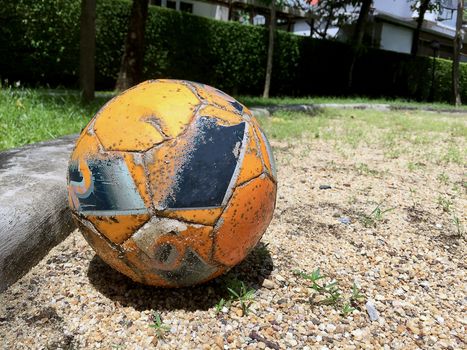 Closeup Old soccer ball on the sand