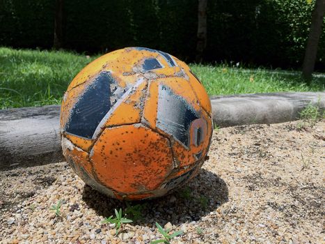 Closeup Old soccer ball on the sand