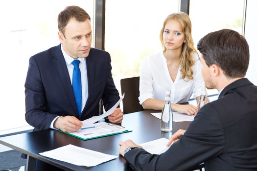 Group of business people discussing with analyzing data financial reports at the office desk