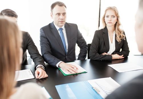 Group of business people discussing with analyzing data financial reports at the office desk
