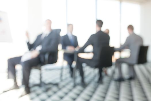 Abstract defocused background of business people in office at meeting table