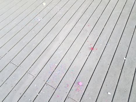 colorful cracked egg shells and paper confetti on wood deck