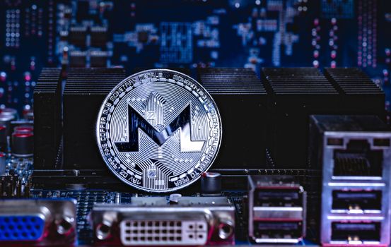 Front view of Monero cryptocurrency over computer video card.Bitcoin mining farm concept.