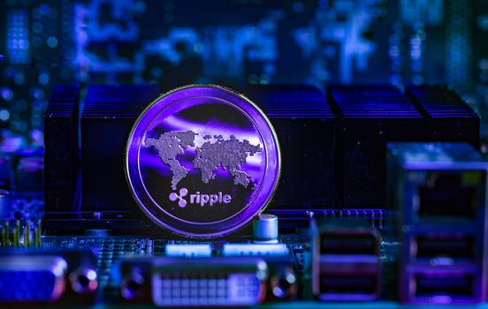 Front view of Ripple(XRP) cryptocurrency over computer video card.Bitcoin mining farm concept.