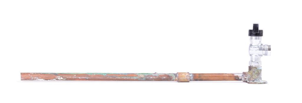 Old brass pipe with metal valve, isolated on a white background