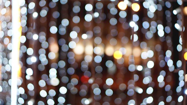 Christmas gold background. Golden holiday glowing backdrop. Defocused Background With Blinking Stars. Blurred Bokeh curtain