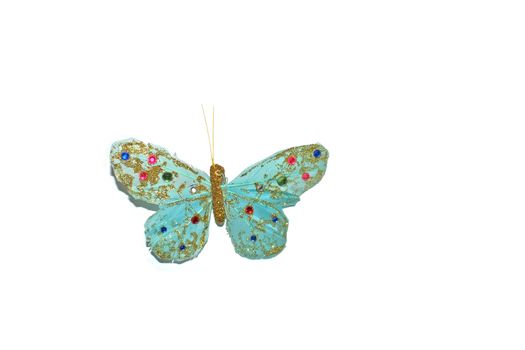 Handmade turquoise butterfly with pink and blue beads isolated on white