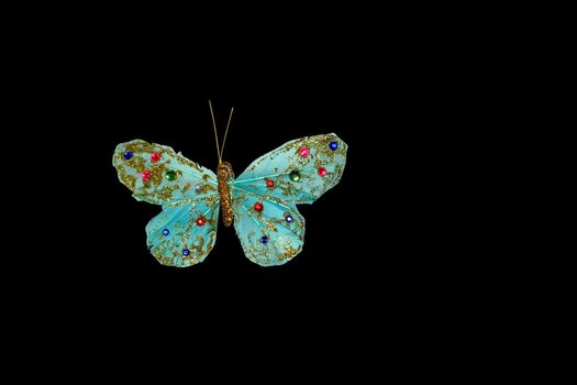 Handmade turquoise butterfly with pink and blue beads isolated on white