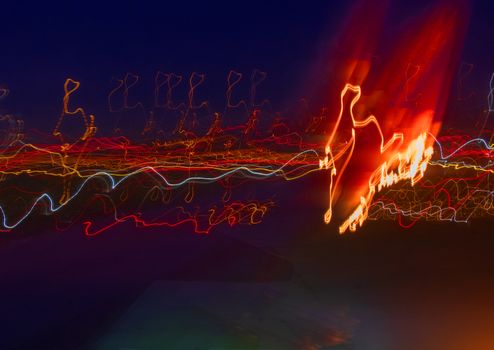 Light painting abstract background texture movement light in dark in various colors.