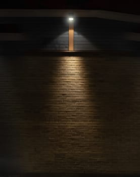 Brick and wood wall background in darkness with lights in triangular shape