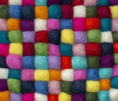 Colorful felted little balls full frame decorative background.