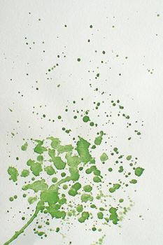Green wet splatter watercolor background texture fresh flow drops and strokes on paper.