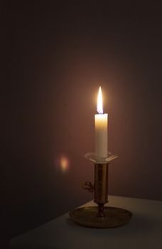 Simple candle burning in darkness, various concepts of darkness to light, prayer symbolism, illumination, awakening and more.