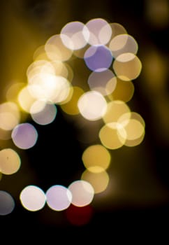 Bokeh lights defocussed festive winter background texture gold and purple colors