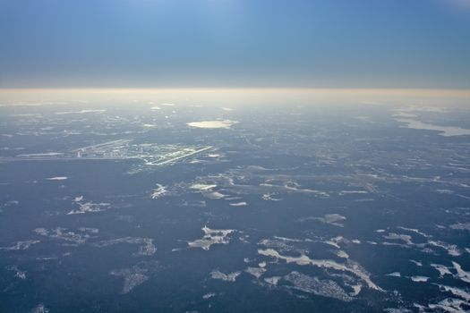 Aerial view over Arlanda airport in sunhaze, Sweden in February.