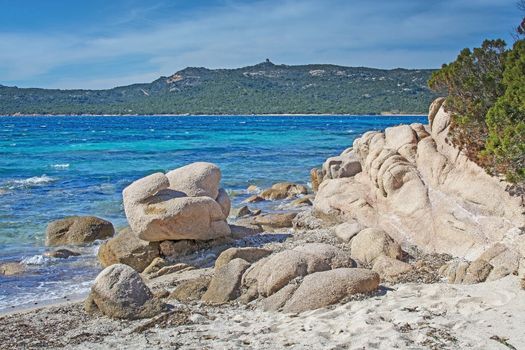 Green water and funny granite rock shapes on a beach in Costa Smeralda, Sardinia, Italy in March.