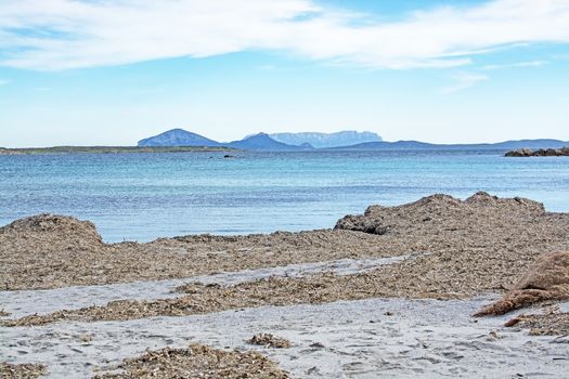 Green water and funny granite rock shapes on a beach in Costa Smeralda, Sardinia, Italy in March.