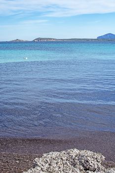 Green water and funny granite rock shapes on a beach in Costa Smeralda, Sardinia, Italy in March.