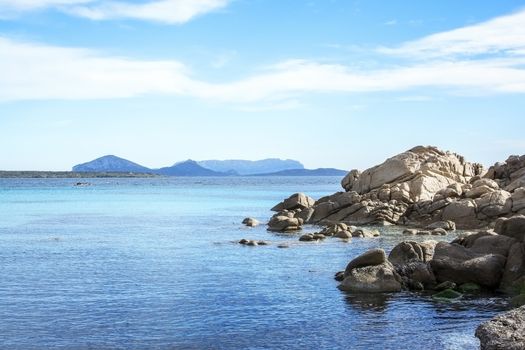Green water and granite rock archipelago landscape on a beach in Costa Smeralda, Sardinia, Italy in March.