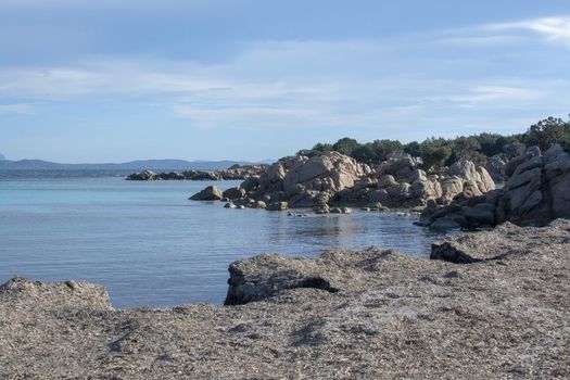 Green water and funny granite rock shapes on a beach in Costa Smeralda, Sardinia, Italy in March.