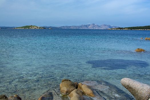Green water and funny granite rock shapes on a beach in Costa Smeralda, Sardinia, Italy in March.