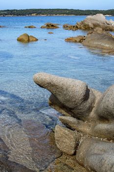 Green water and funny granite rock shapes on a beach in Costa Smeralda, Sardinia, Italy in March.