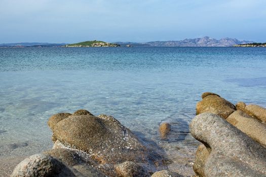 Green water and funny granite rock shapes on a beach in Costa Smeralda, Sardinia, Italy in March.