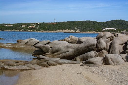 Green water and funny granite rock shapes on a beach in Costa Smeralda, Sardinia, Italy in March.