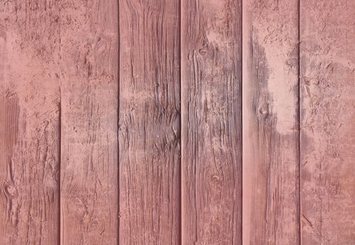 Weathered wood background texture. Old rugged planks with screws for background texture toned in Living Coral color