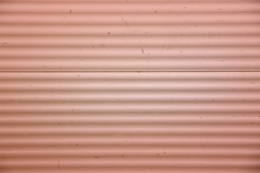 Corrugated iron background toned in trend color Living Coral.